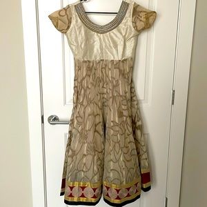 Cream colored Anarkali salwar kameez with red&black border and a beaded neckline